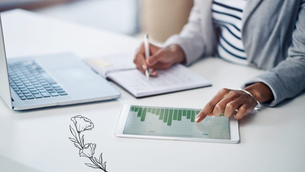 A person looking into a bar graph and taking notes