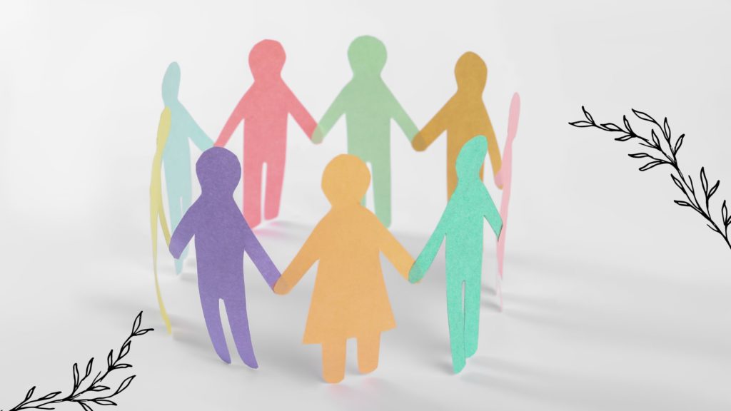 Paper cut out people holding hands and standing in a circle