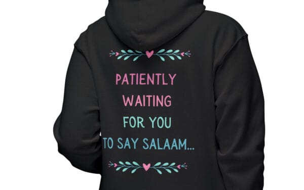 hijabi hoodie sweatshirt black in color worn by a woman facing away